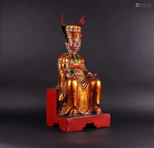 A large wooden, partly gilded, statue of an Emperor. China, ...