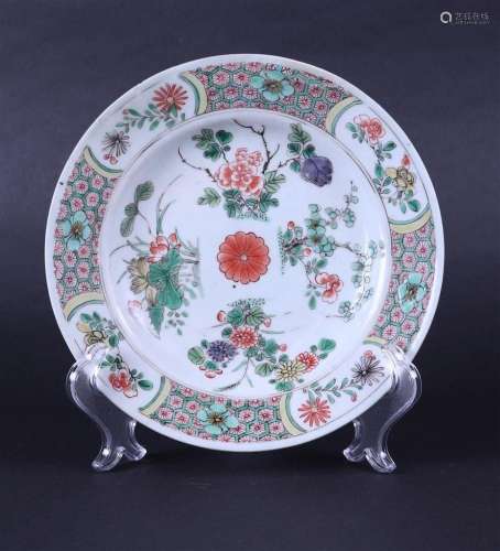 A porcelain Famile Verte plate with decor including flowers ...