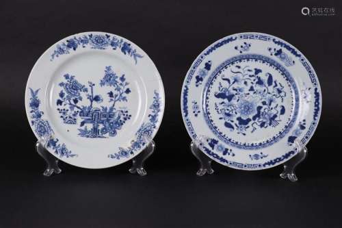 Two porcelain plates, both with floral decor, one with cache...