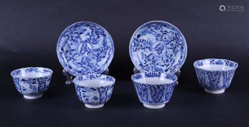 A set of porcelain cups and saucers with floral decor and ri...