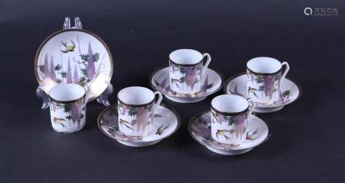 A set of five porcelain cups and saucers decorated with wist...