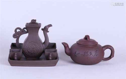 A lot consisting of a Yixing teapot, a ditto pot and four cu...