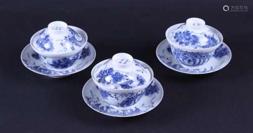 A set of three blue and white lidded cups and saucers, marke...
