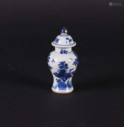 A porcelain baluster-shaped lidded vase with a rich floral d...