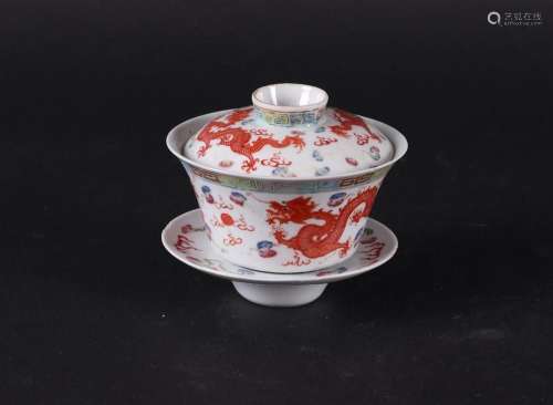 A porcelain Famile Rose lidded bowl with dish with dragon de...