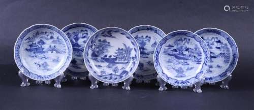 A set of porcelain dishes decorated with pagoda's in a lands...