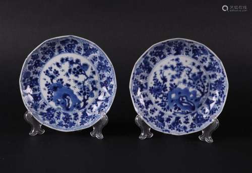 Two porcelain angled plates with floral decor on rock with i...