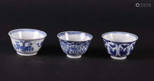 Three various porcelain bowls with antique decor and two wit...