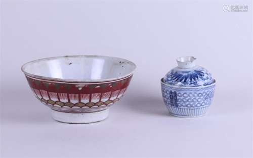 A porcelain bowl with floral decor, with a blue and white li...