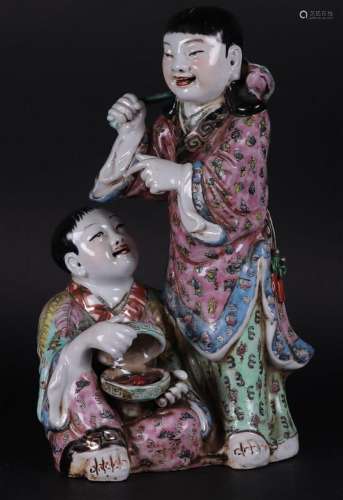 A porcelain Famile Rose group of two children, marked on the...