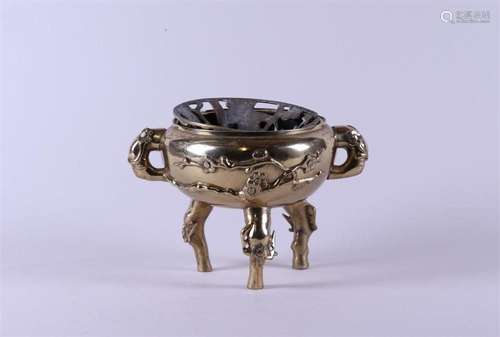 A bronze incense burner decorated with blossom branches, mar...