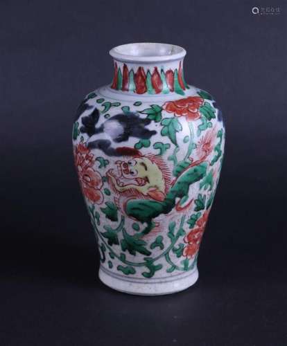 A porcelain Wucai vase decorated with dragons and flowers. C...