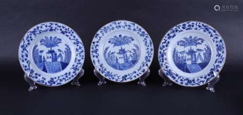 Three porcelain plates with a decoration of a house in a lan...