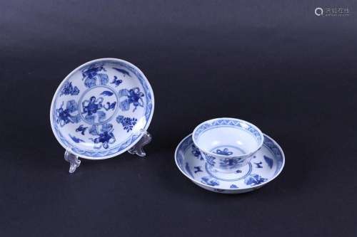 A set of two porcelain plates and a cup decorated with frost...