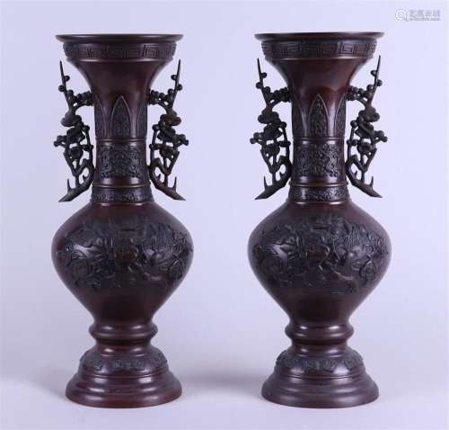 A set of two bronze vases decorated with flowers and birds. ...