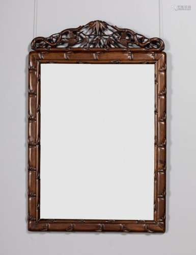 A Chinese hardwood framed mirror with pierced and scrolled c...