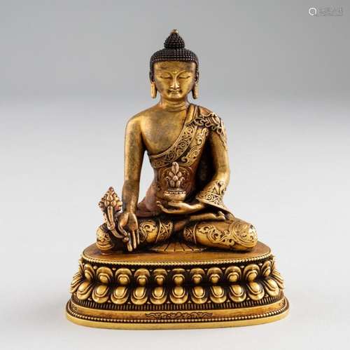 A gilt copper alloy seated figure of Buddha. 4 1/8 in. (10.5...