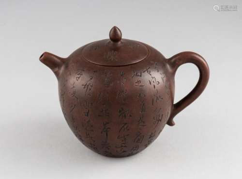 A Chinese purple clay teapot, 4 1/2 in. (11.4 cm.) h.