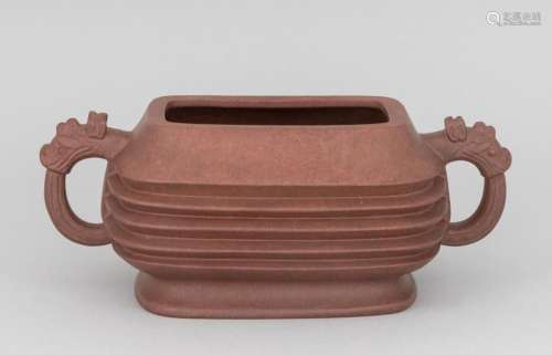 A Chinese red clay Yi Xing ribbed oval bowl with dragon mask...