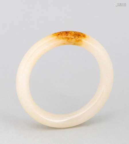 A lady\'s russet white jade bangle. 2 1/4 in. (5.7 cm.) inne...