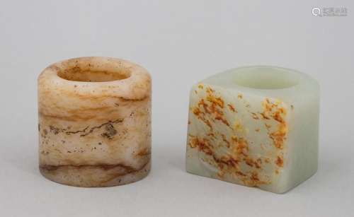 A Chinese light celadon and russet archer\'s ring together w...