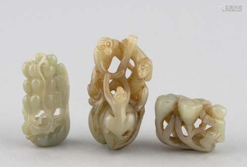 Three Chinese celadon jadeite carvings depicting fruit, monk...