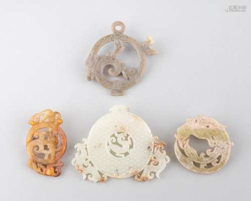 Four Chinese jadeite bi discs pierced with dragons and figur...