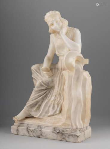 A white alabaster sculpture of a seated woman next to a topp...