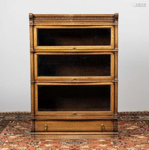 An oak barrister\'s bookcase with three shelves and a base d...