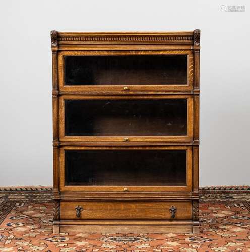 An oak barrister\'s bookcase with three shelves and a base d...