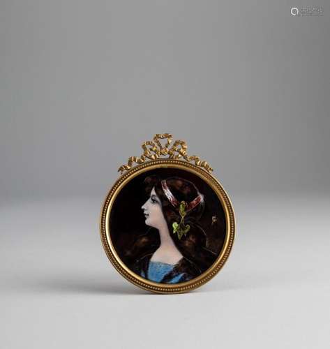 A round French enameled miniature portrait of a young maiden...