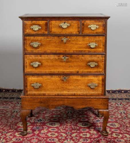An 18th century oak and yew wood cross banded chest on stand...