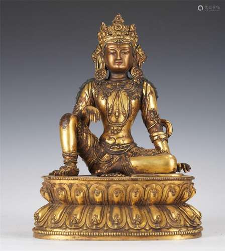 A TIBETAN BRONZE-GILT SEATED DEITY