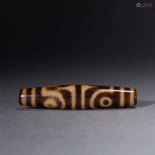 A FINE AND RARE TIBETAN DZI BEAD