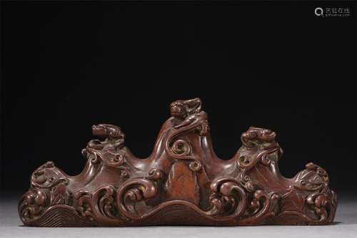 A CHINESE BRONZE CHILONG BRUSHREST