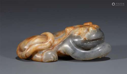 A CHINESE CARVED JADE FELINE