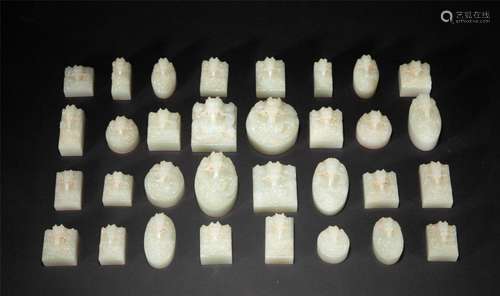 A RARE COLLECTION OF CARVED WHITE JADE DRAGON SEALS