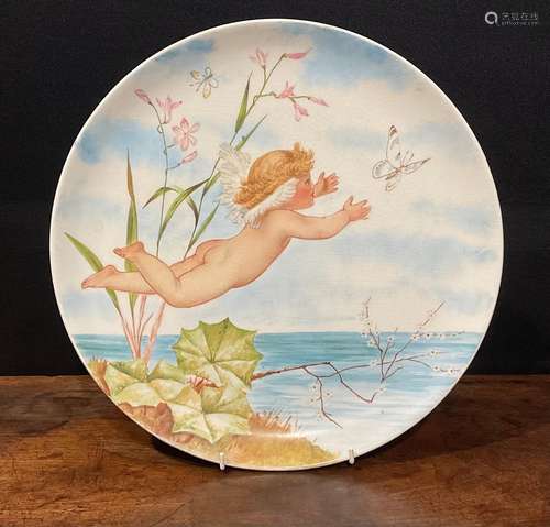 An Aesthetic Movement circular charger, painted with cherub ...