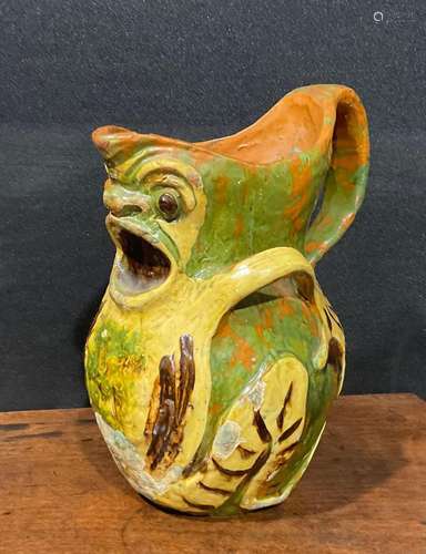 A late 19th century terracotta grotesque jug, by Blanche Vul...