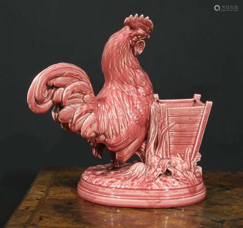 A Majolica novelty vase, modelled as a cockerel beside a woo...