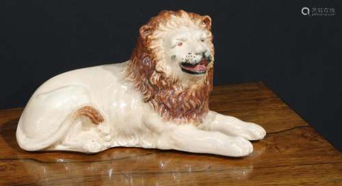 An English pottery lion, modelled recumbent and slip cast, 2...
