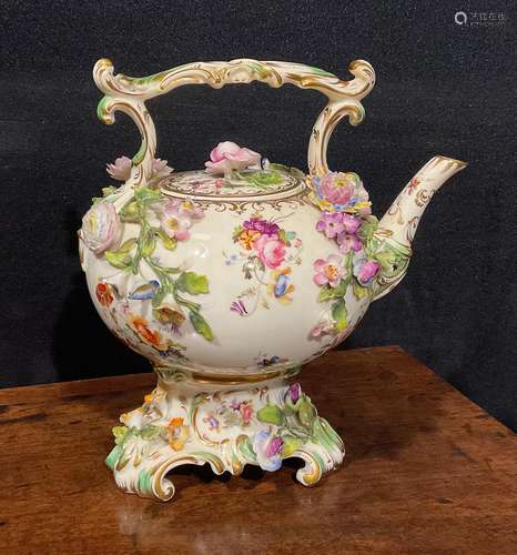 A Coalbrookdale teapot and stand, painted with flowers and i...