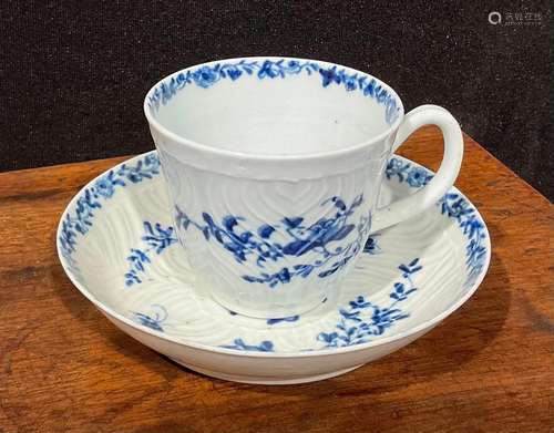 A Worcester feather moulded coffee cup and saucer, painted i...