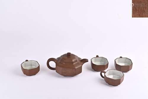 A set of purple clay pots and tea sets