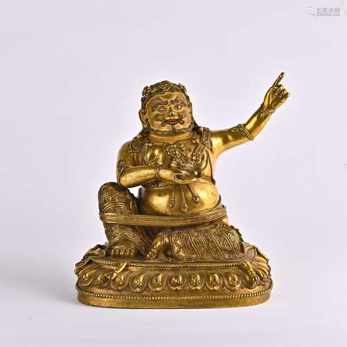 Gold plated figure of the god of wealth sitting on lotus