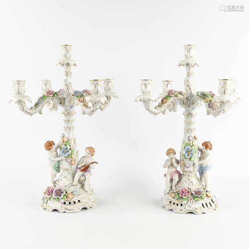 A pair of candelabra, polychrome porcelain decorated with fi...