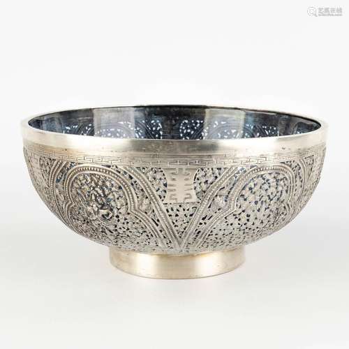 A Chinese bowl, silver with a blue glass liner, decorated wi...