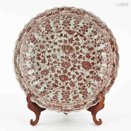 A large Chinese plate with red glaze, peonies. 19th/20th C. ...