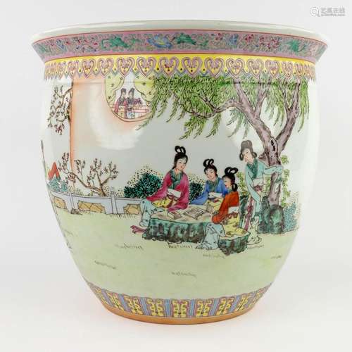 A large Chinese cache-pot decorated with figurines in a gard...