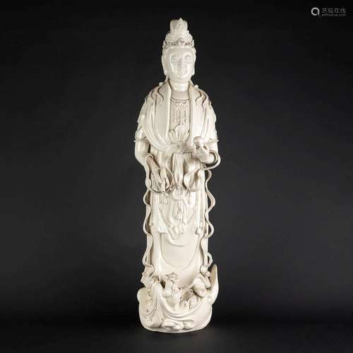 A large Chinese Guanyin figurine, blanc de chine porcelain. ...